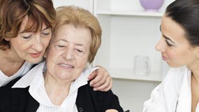 Caregiver with mother and nurse