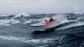 Men in raft in stormy sea