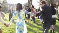 Family dancing and having fun outdoors.