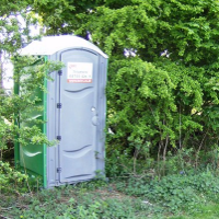 A port-a-potty which is convenient but still crappy