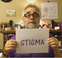 Brian LeBlanc holding card that says Stigma