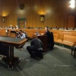 Seth Rogen speaking about the devastation of Alzheimer's disease before an empty Senate Committee