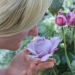 Woman with dementia smelling a flower