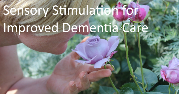 Woman with Alzheimer's smelling a rose