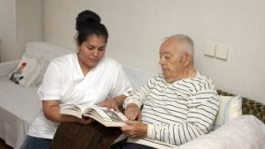 Home care professional helping man with dementia